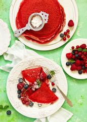 Pancakes are red velvet, with berries and cream. Valentine's Day. Selective focus.