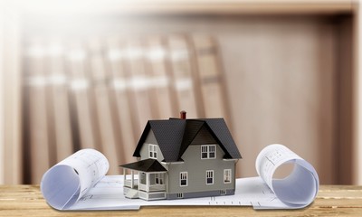 Classic house model on blueprint on white background