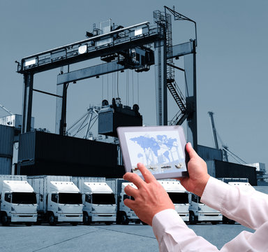 Transportation import export concept,Man hand holding cell phone or tablet  automate wireless for control drlivery shipment