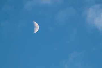 Half waxing Moon in blue sky