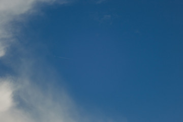 Scattered white clouds on blue sky. Copy space