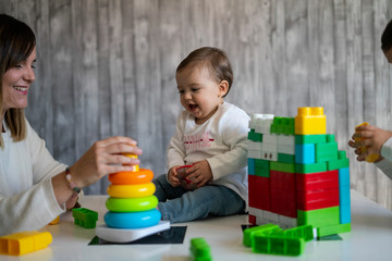 Happy baby playing with toy blocks.