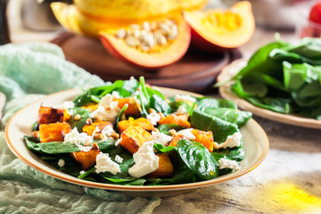 Roasted pumpkin salad with spinach and nuts