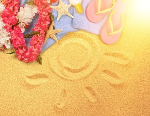 Beach accessories on sand. Flip flops, sunglasses, sea star