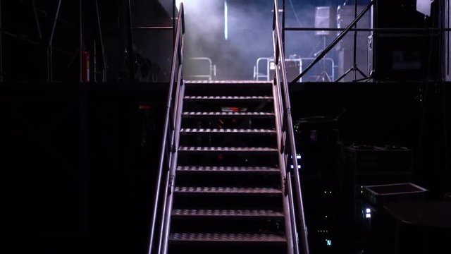 Different parts of an concert or presentation stage and its lighting, sound, wires and different areas of the performance setup with instruments in view. Go up the stairs to play concert.