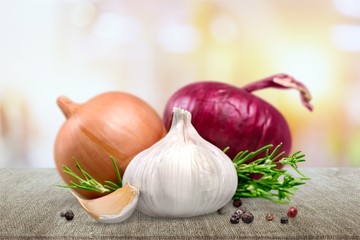 Garlic and onion with peppercorn and parsley isolated on white