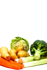 Close up of uncooked cauliflower,parsnips, carrots,potatoes,broccoli and leeks isolated on a white background