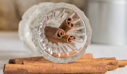 Cinnamon sticks in glass jar. Close up, copy space, mockup