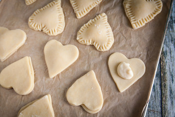 Fototapeta na wymiar Homemade heart shape cookies with vanilla custard cream