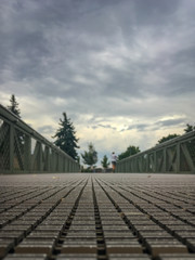 Obraz premium Blurred man running jogging on a bridge. Health activities, exercise by runner.