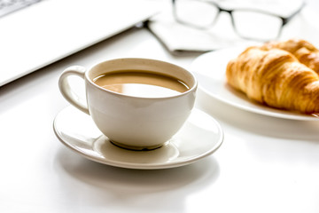 Office breakfast with laptop on white desk