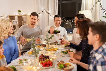 celebration, holidays and people concept - happy family having dinner party at home