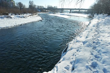 Panorama of the riverbed of a mountain river on a sunny winter day