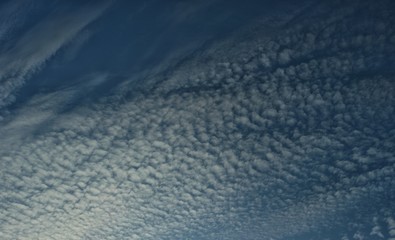 Cirrocumulus clouds against blue sky, background