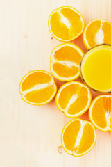Glass of freshly pressed orange juice with sliced orange halfs