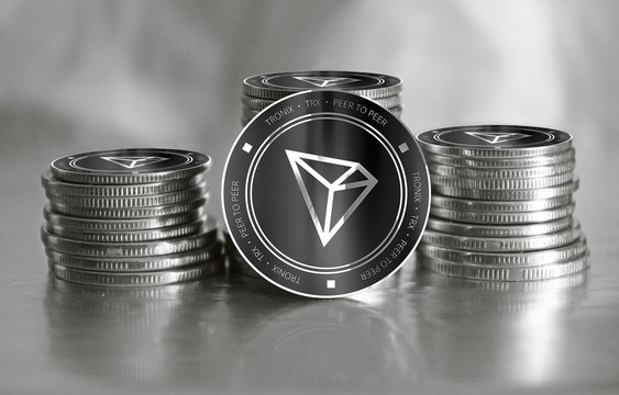Tronix (TRX) digital crypto currency. Stack of black and silver coins. Cyber money.