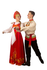 Beautiful caucasian cuple dancing in Russian folk costumes isolated on white