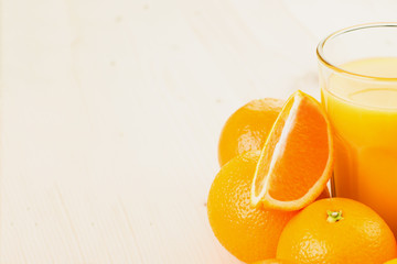 Glass of freshly pressed orange juice with oranges
