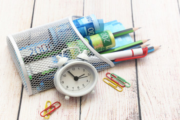 Russian money, alarm clock, pen and pencils. Business still-life