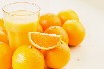 Glass of freshly pressed orange juice with oranges
