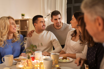 celebration, holidays and people concept - happy family having tea party at home