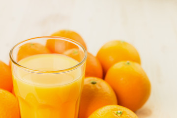 Glass of freshly pressed orange juice with oranges