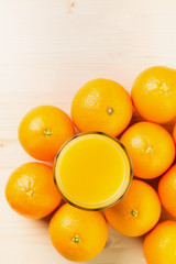 Glass of freshly pressed orange juice with oranges
