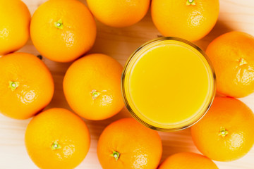 Glass of freshly pressed orange juice with oranges