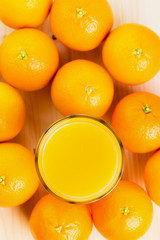 Glass of freshly pressed orange juice with oranges