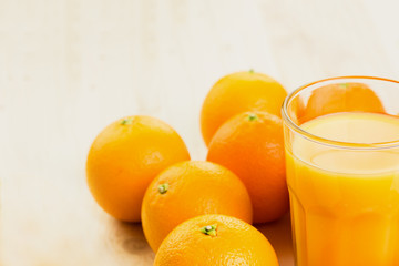 Glass of freshly pressed orange juice with oranges