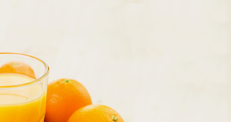 Glass of freshly pressed orange juice with oranges