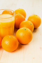 Glass of freshly pressed orange juice with oranges
