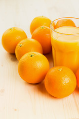 Glass of freshly pressed orange juice with oranges