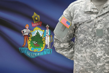 American soldier with US state flag on background - Maine