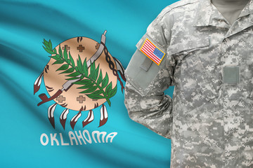 American soldier with US state flag on background - Oklahoma