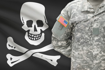 American soldier with flag on background - Jolly Roger - symbol of piracy
