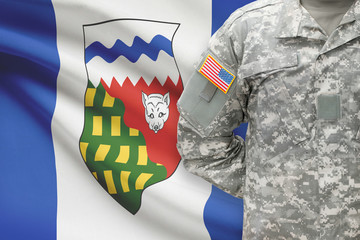 American soldier with Canadian province flag on background - Northwest Territories