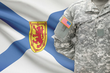 American soldier with Canadian province flag on background - Nova Scotia