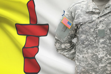 American soldier with Canadian province flag on background - Nunavut
