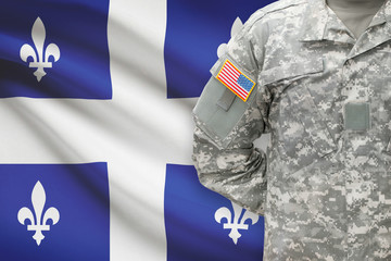 American soldier with Canadian province flag on background - Quebec