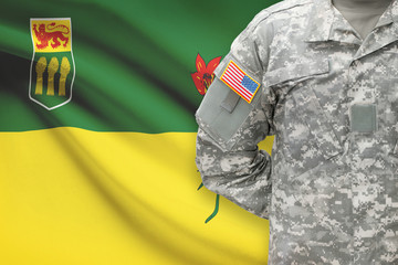 American soldier with Canadian province flag on background - Saskatchewan