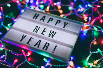 lightbox with Happy New Year message surrounded by colorful fairy lights