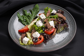 Fresh salad with veal, cheese feta and vegetables