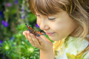 child with a butterfly in his hands. Selective focus.