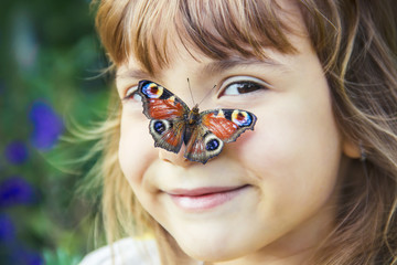 child with a butterfly in his hands. Selective focus.