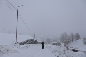 Stepantsminda Village in a snowstorm in winter in Kazbegi District , Mtskheta-Mtianeti Region, Georgia. 