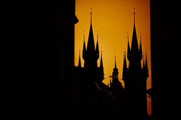  roofs of prague silhouette of the town hall and the church of Prague at sunset yellow