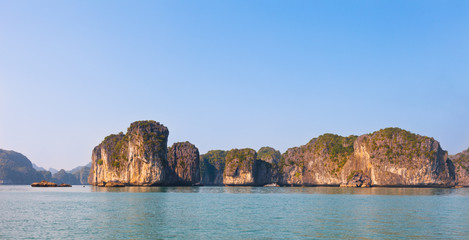 Fototapeta na wymiar Panoramical landscape of Ha Long Bay in north Vietnam. The bay consists of a dense cluster of some limestone monolithic islands each topped with thick jungle vegetation, rising from the ocean.
