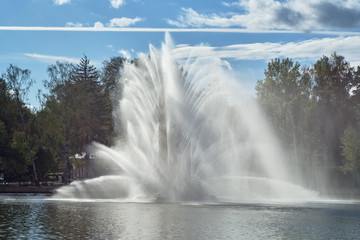 Park fountain in backlit on a sunny day