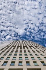 Fototapeta na wymiar Modern building skyscraper against the sky with beautiful clouds